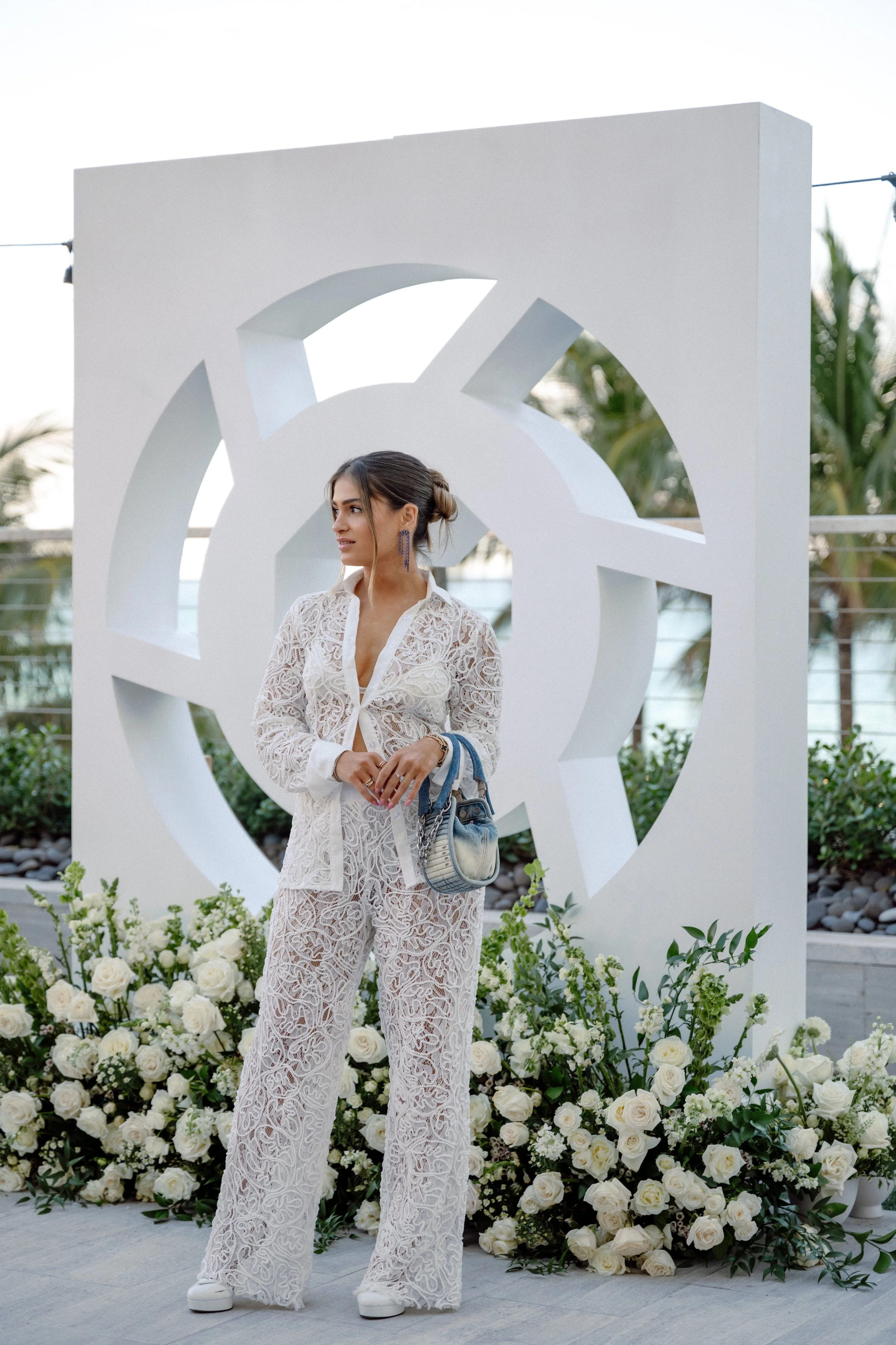 Guest standing beside the white LTK logo sculpture in daylight