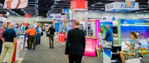 Trade show floor with exhibition booths and attendees