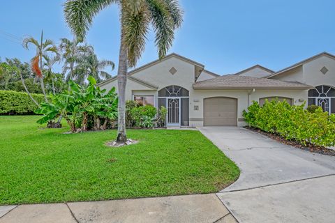 Single-story Florida home with stucco exterior and palm tree at 3135 Nw 13th Street, Delray Beach