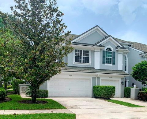 Two-story light-blue townhome with two-car garage at 14360 Strathmore Lane, Delray Beach