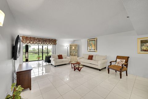 Bright Florida condo living room with white tile floors and window view at 350 N Federal Highway, Boynton Beach