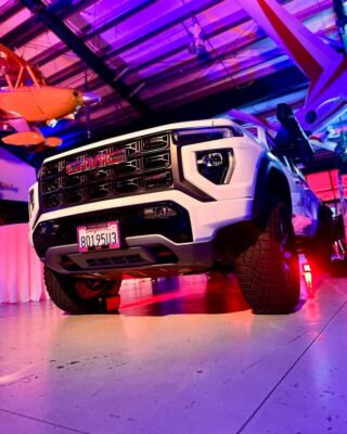 White GMC truck reveal with purple and red lighting