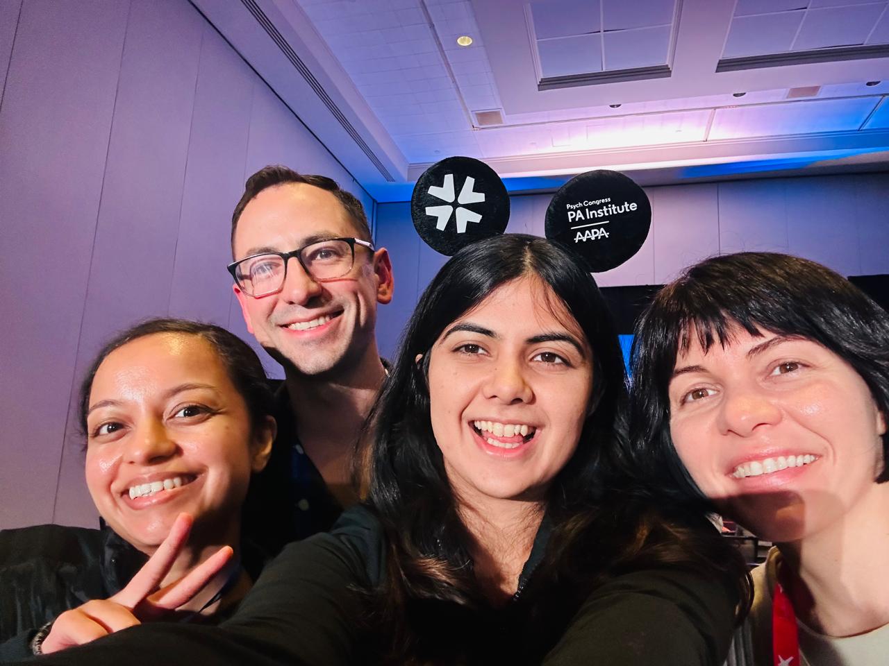 Four members of the Lavender Health team taking a selfie at the Psych Congress PA Institute event