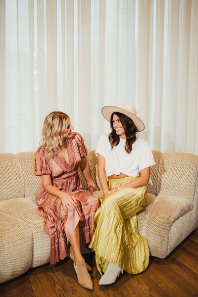 LB Events team chatting on a cream sofa