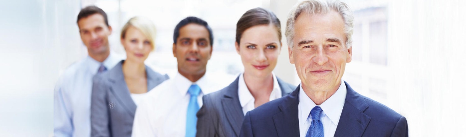 Leadership coaching in Orange County, California — five business professionals standing in an office corridor