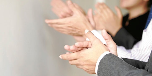Close-up of people clapping in appreciation