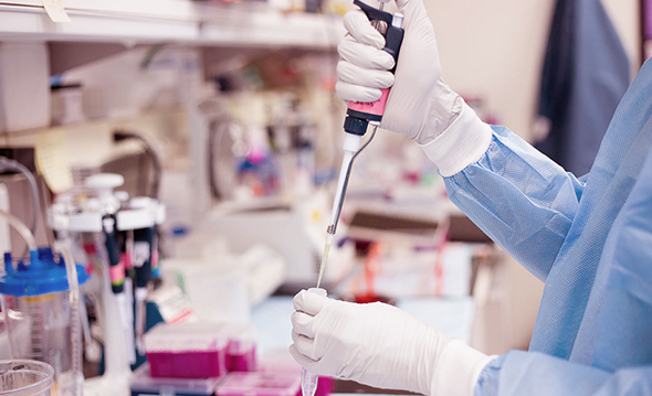 Lab technician pipetting samples in a laboratory