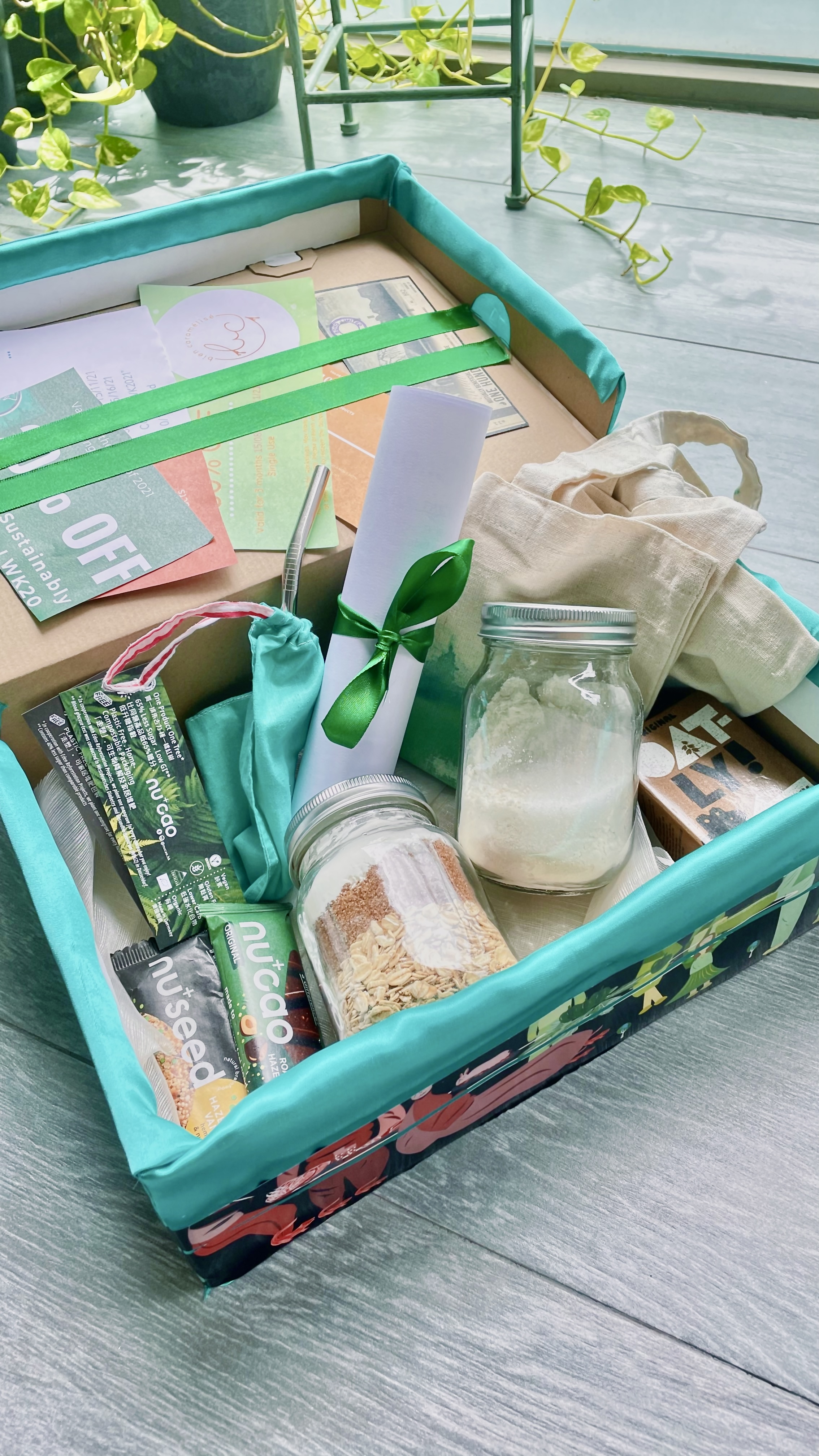 Open LWK Challenge Package box with mason jars, oats, vegan snacks, a metal straw, a tote bag and a scrolled certificate