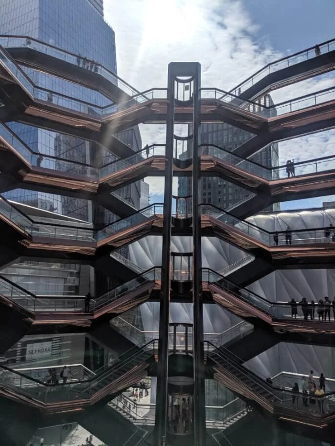 Looking up from inside The Vessel at Hudson Yards, skyscrapers above