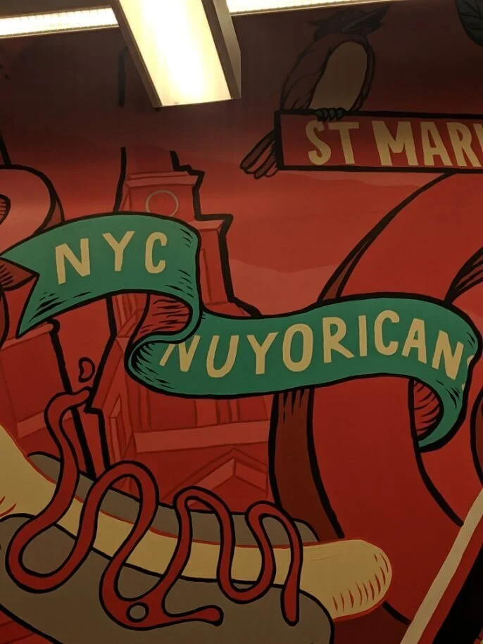 NYC Nuyorican illustrated mural with a St. Mark's Place banner, East Village