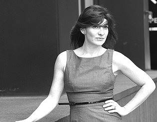 Black-and-white portrait of Rachel Einbund standing outdoors in a sleeveless dress