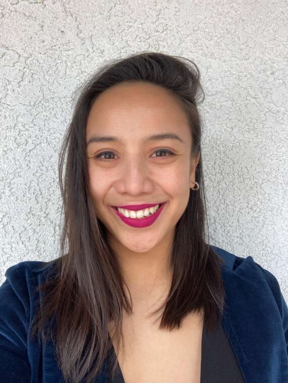 Portrait of Katrina Ceguera, smiling in a navy blazer