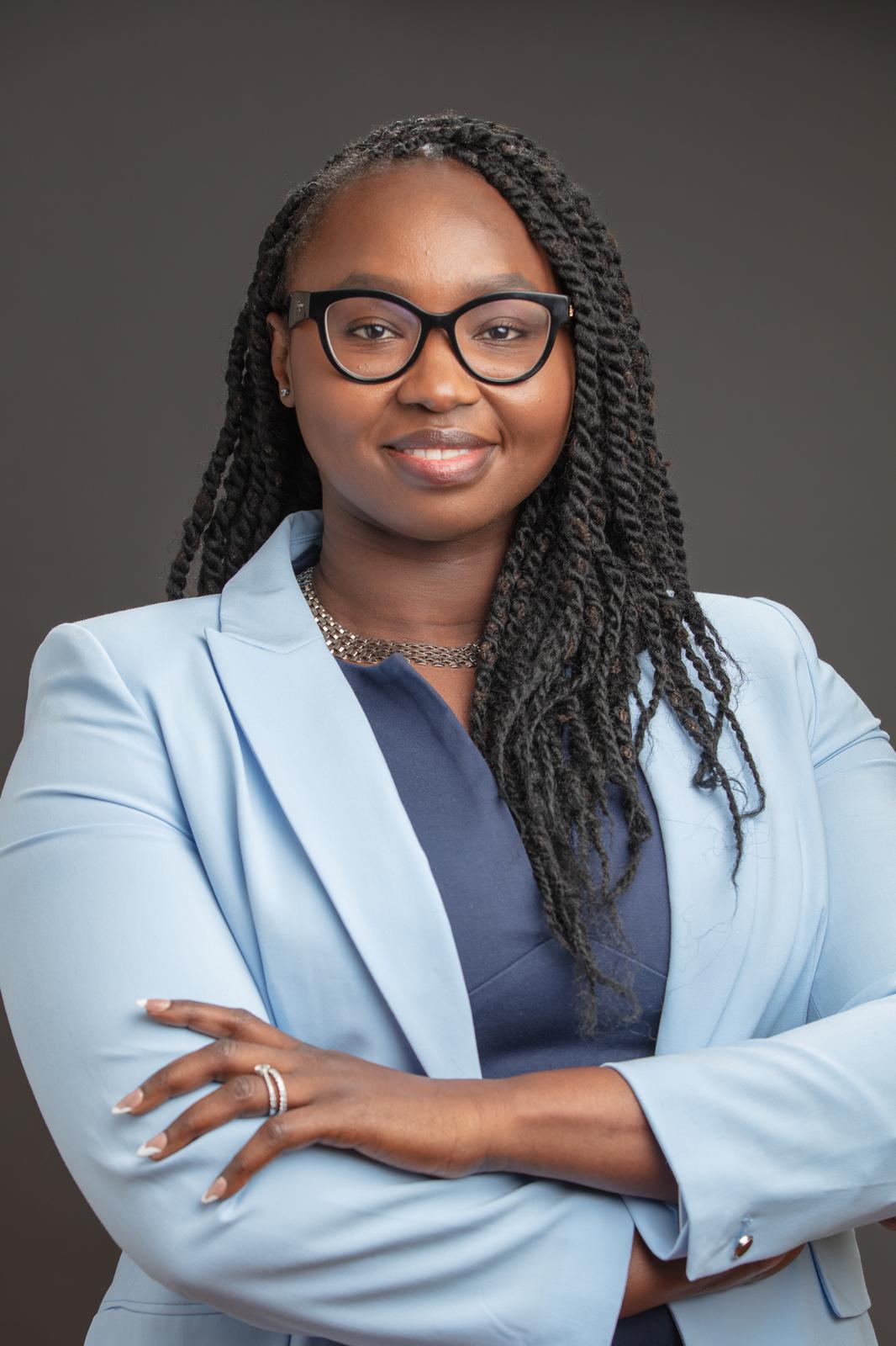Portrait of Irene Itol, wearing a light blue blazer with arms crossed