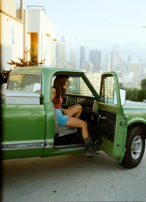 The founder smiling from the cab of the truck.
