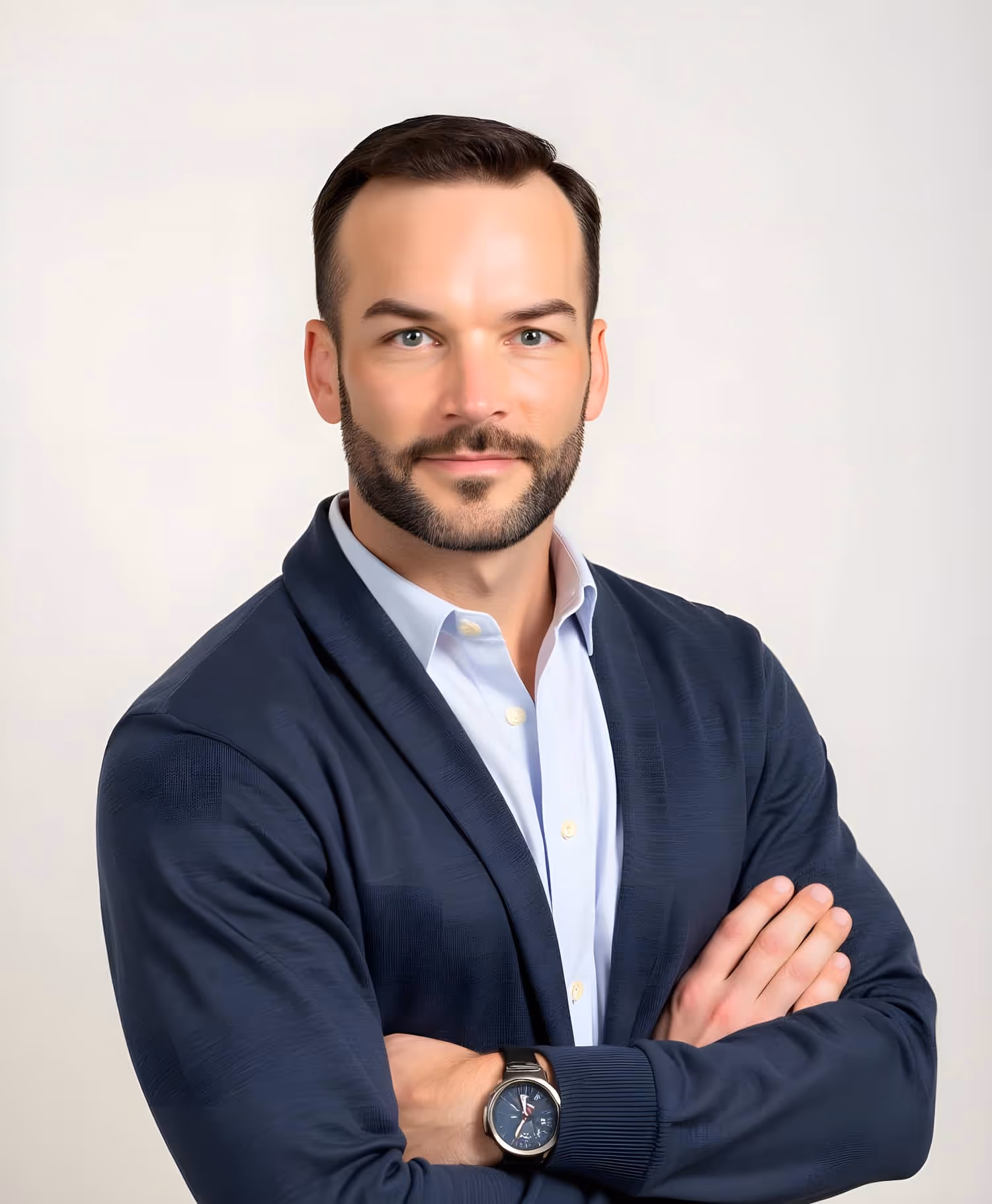 Dr. Matt Morscheck in a navy blazer with arms crossed