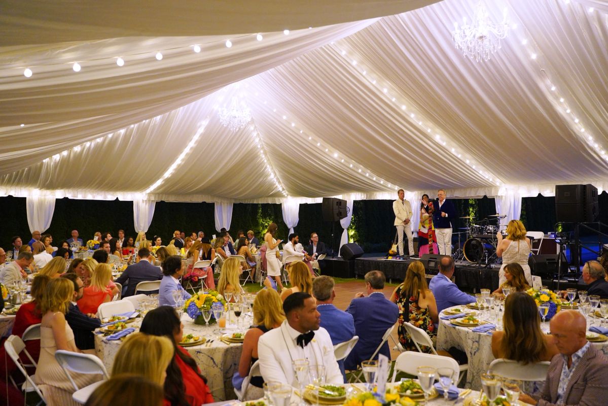 Tented gala dinner with chandeliers, alternate crop