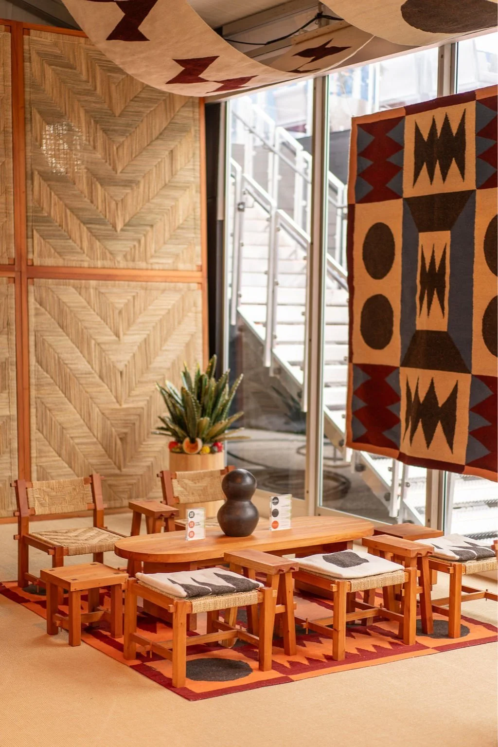 Maestro Dobel branded lounge installation with tapestry and rattan walls at Frieze LA