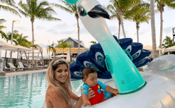 Woman and baby on a giant swan float in a resort pool
