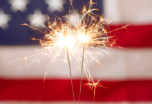 Sparklers burning in front of an American flag