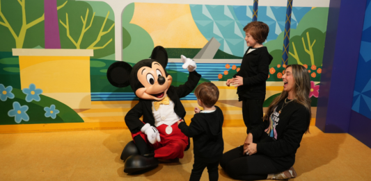 Mom and two children meeting Mickey Mouse at Walt Disney World