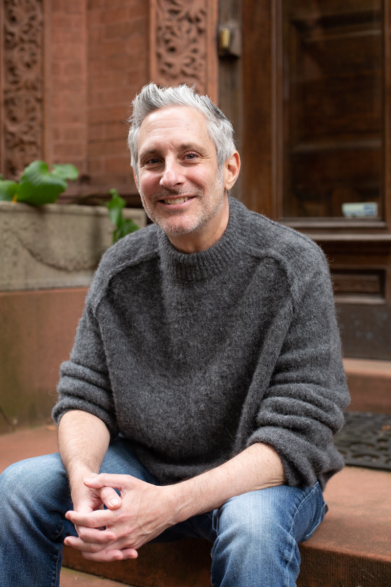Michael Langer sitting on brownstone steps in New York