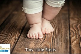 Close-up of a baby's feet on a wooden floor