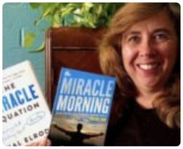 Woman holding Miracle Morning and Miracle Equation books