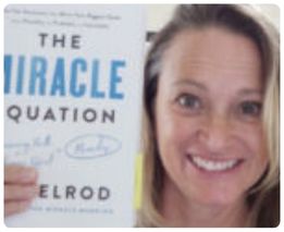 Woman holding The Miracle Equation book