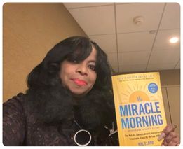Woman holding The Miracle Morning book