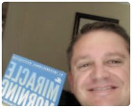 Man holding The Miracle Morning book