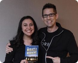 Couple holding The Miracle Morning book