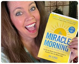 Woman holding The Miracle Morning updated edition