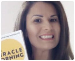 Woman holding The Miracle Morning book