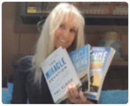 Woman holding multiple Miracle Morning books