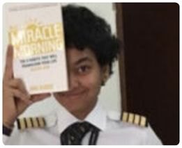 Person holding The Miracle Morning book