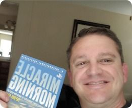 Man holding The Miracle Morning book