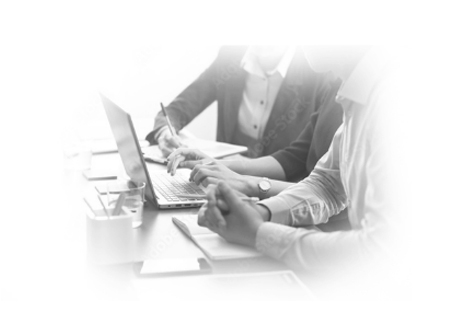 Business people working together with laptops and documents at a table