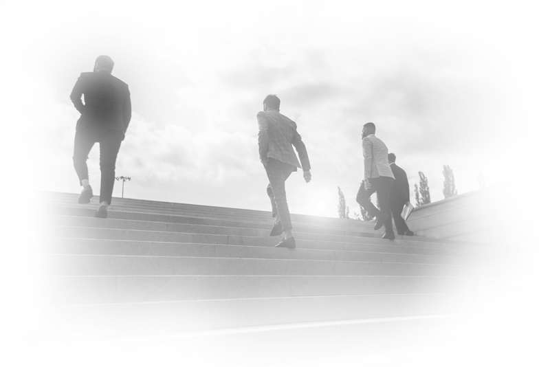 Silhouetted people climbing stairs, representing leadership growth