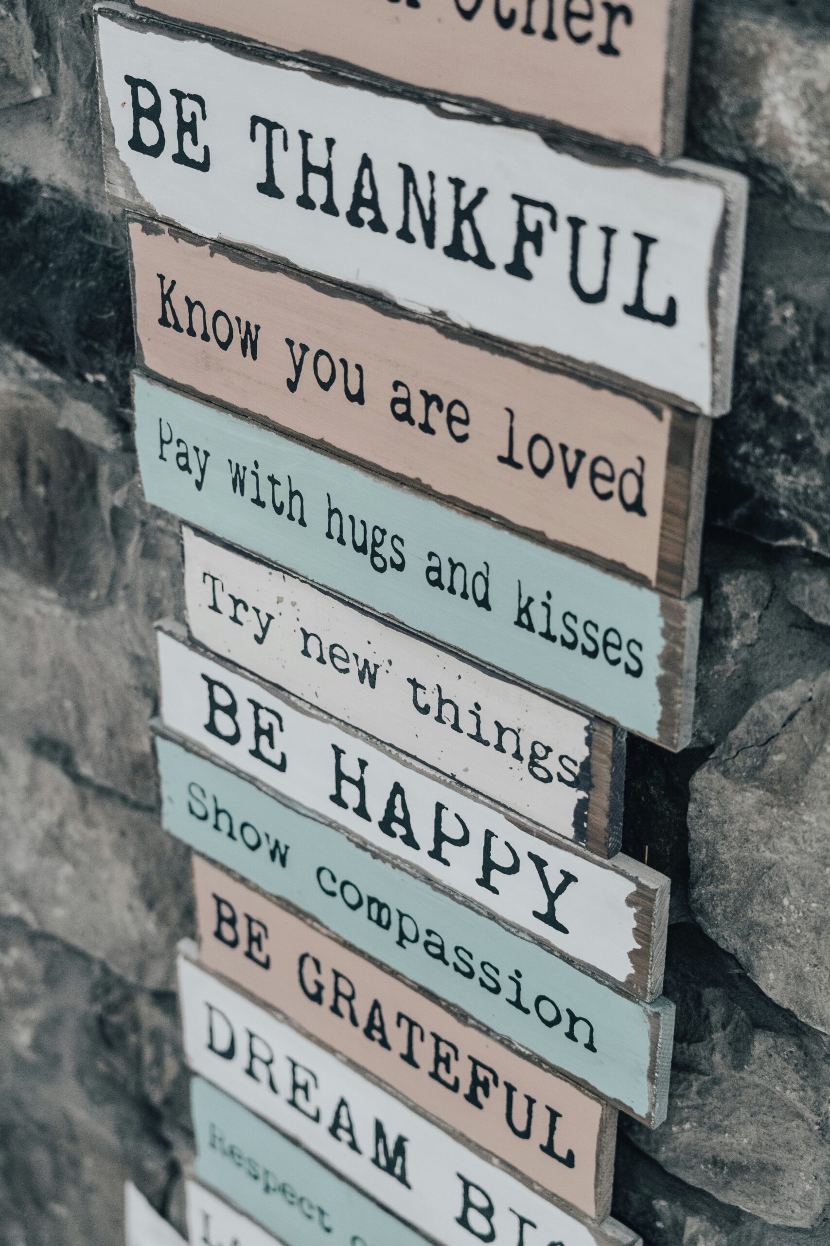 Stack of colorful wooden motivational signs