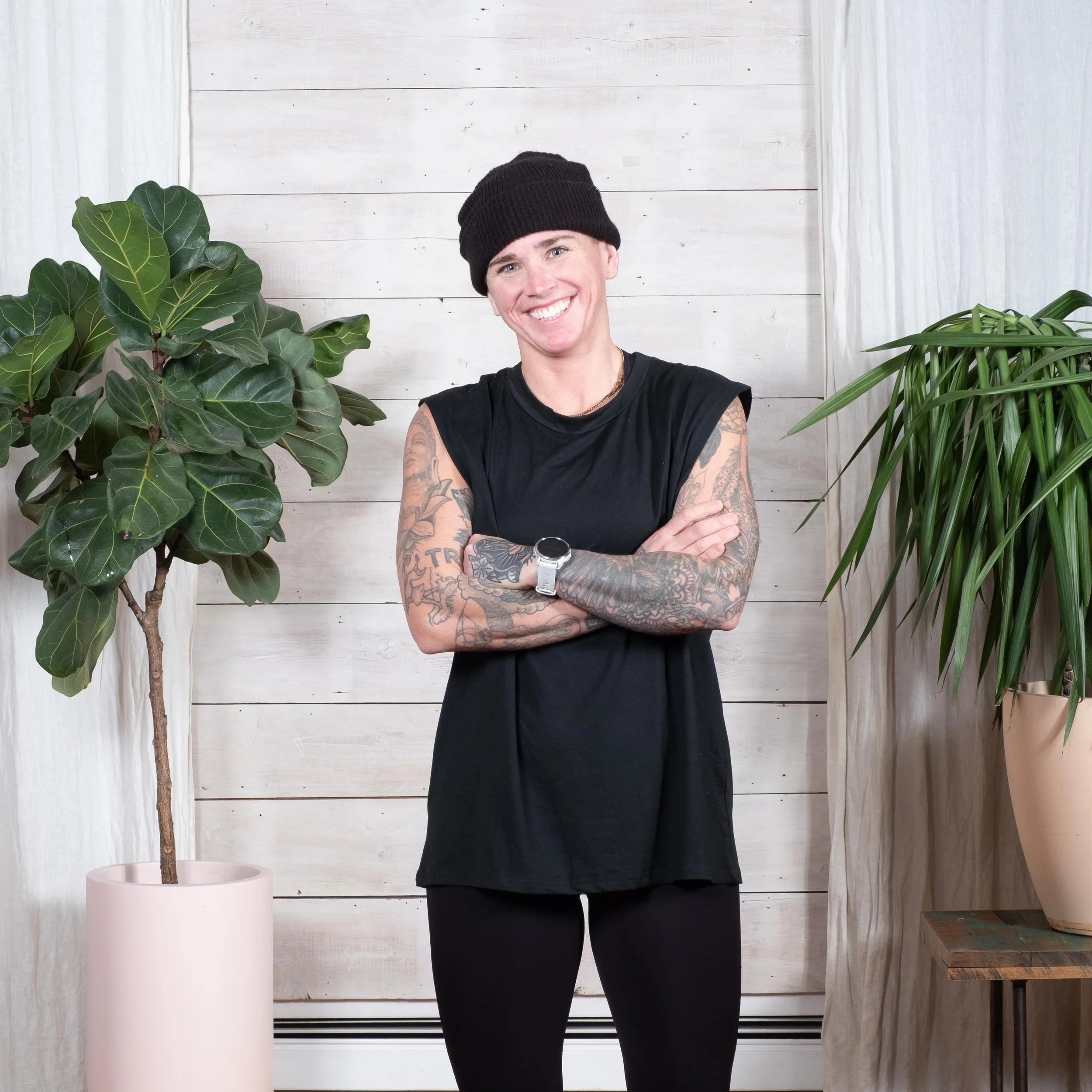 Instagram post: instructor in a black beanie and sleeveless shirt, arms crossed