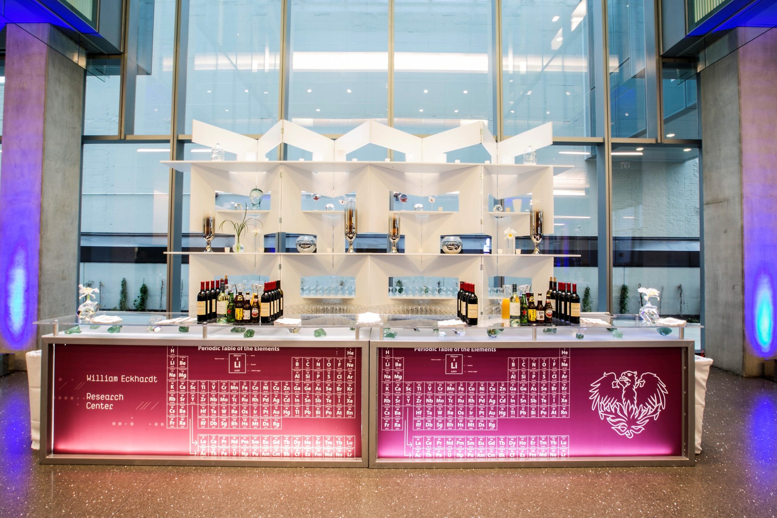 Custom event bar branded with the William Eckhardt Research Center periodic table design in a glass-walled building