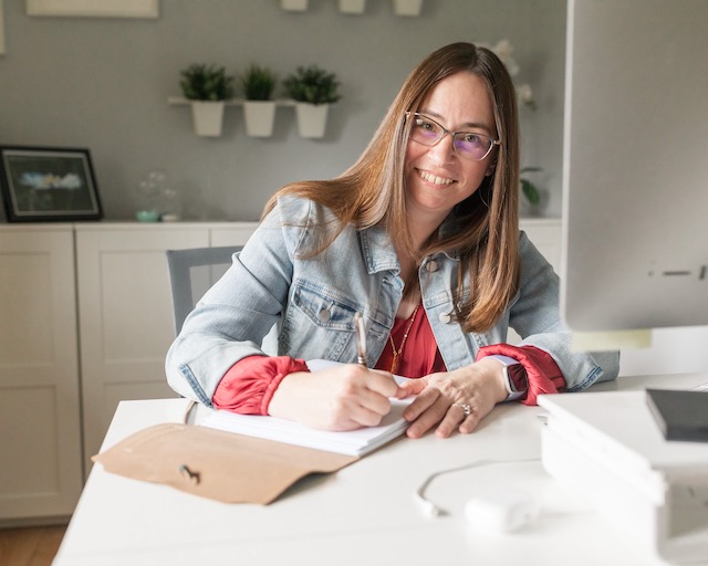 Tish Van Ravenhorst, executive coach and team building consultant, working at her desk