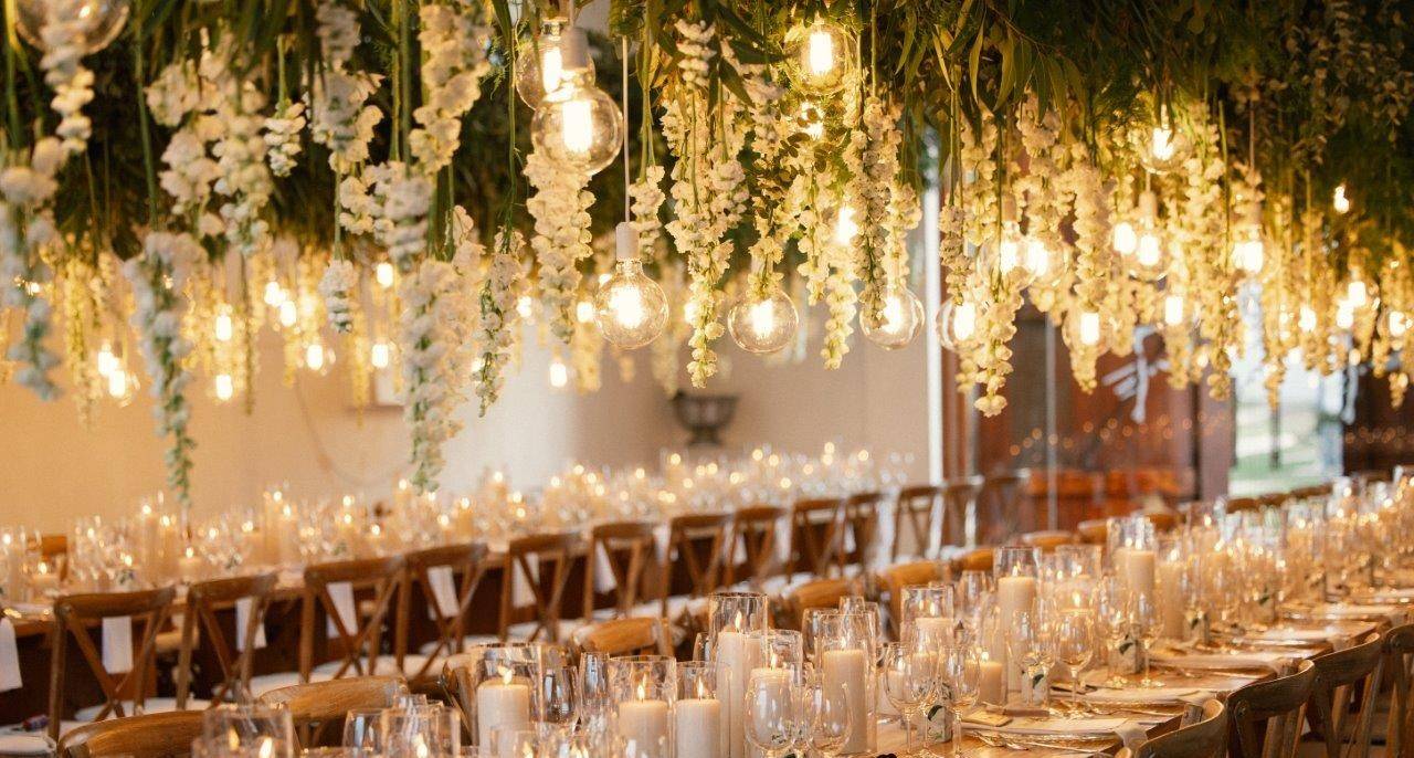 Reception with long banquet tables and hanging globe lights