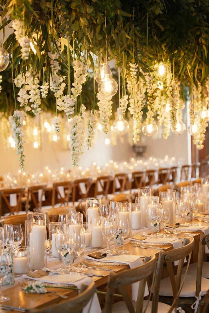 Warm-lit reception with a cascading floral ceiling at Zorgvliet