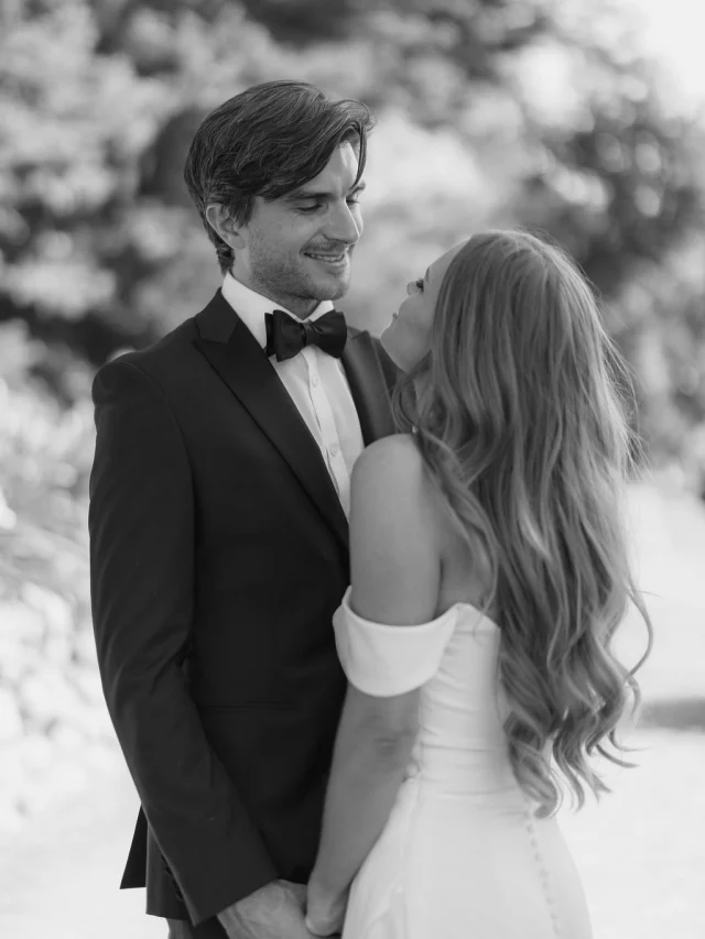 Black-and-white portrait of a bride and groom in a bow tie