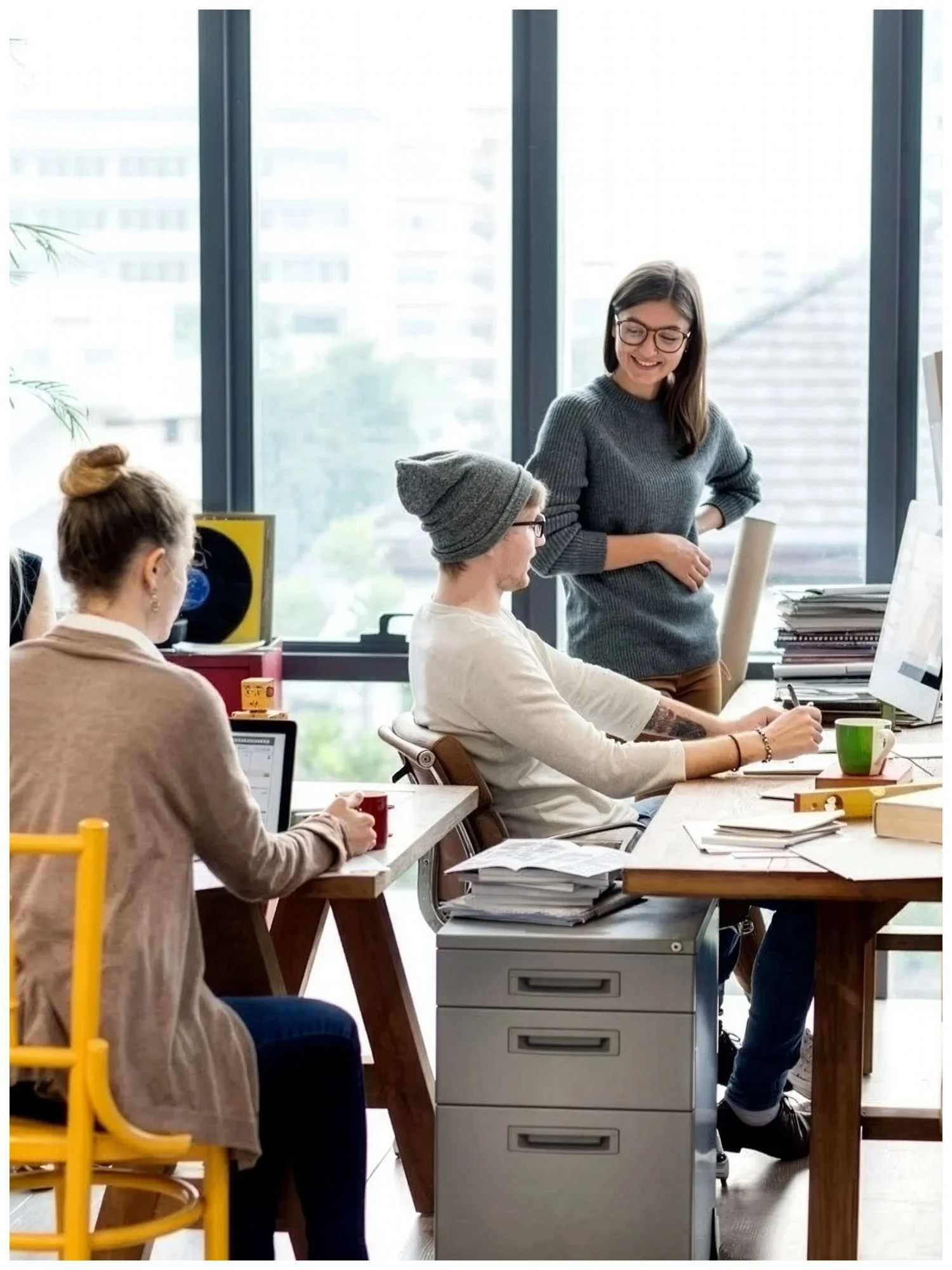 Three colleagues collaborating in a bright open-plan office