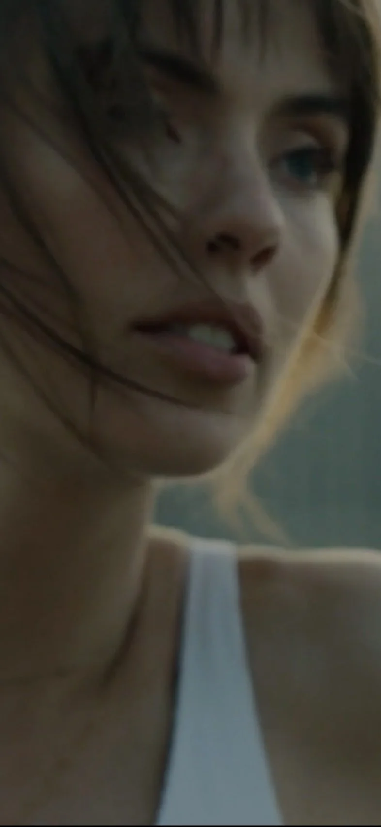 Close-up portrait of a woman outdoors, hair caught in the wind