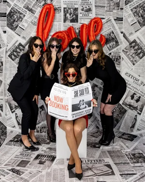 One Fine Day Events team with a Now Booking newspaper prop