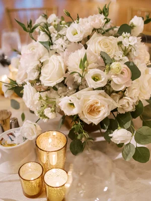 White and blush rose centerpiece with gold votives