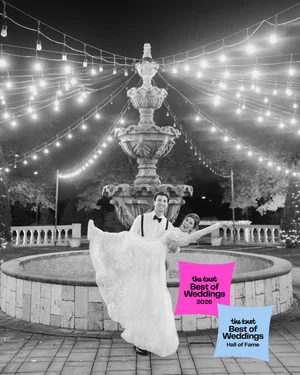 Groom lifting bride by a fountain with The Knot Best of Weddings badges